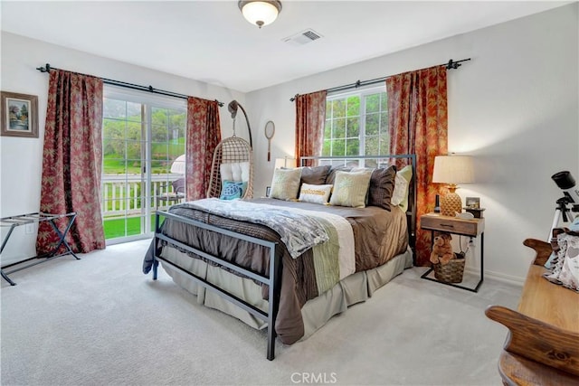 carpeted bedroom featuring multiple windows