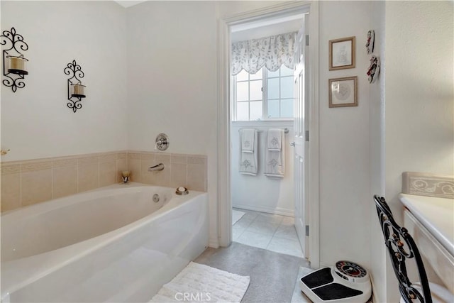 bathroom with tile patterned flooring and a washtub