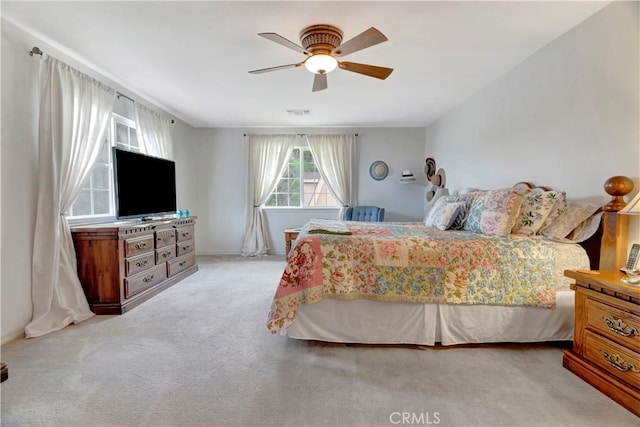 bedroom featuring ceiling fan and light colored carpet