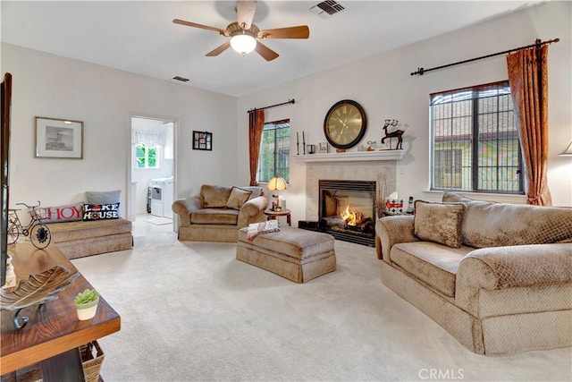 living room with plenty of natural light, ceiling fan, and light colored carpet