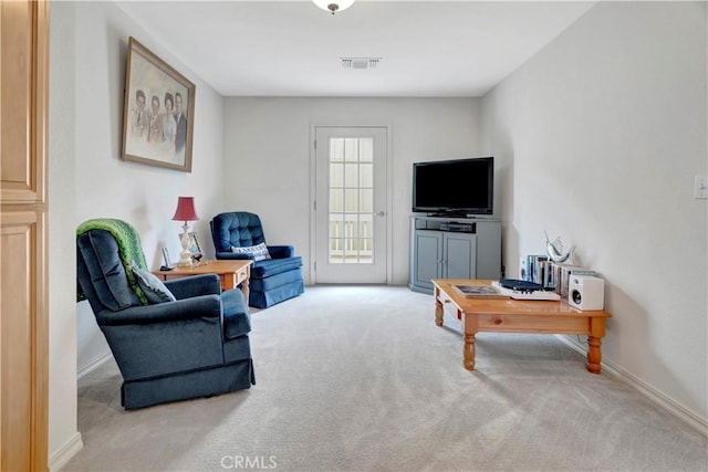 sitting room featuring light carpet