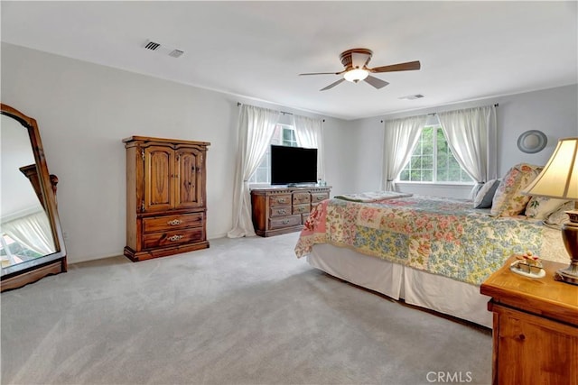 bedroom with ceiling fan and light colored carpet