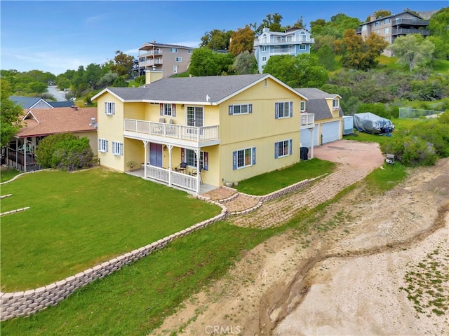 exterior space with a balcony and a yard