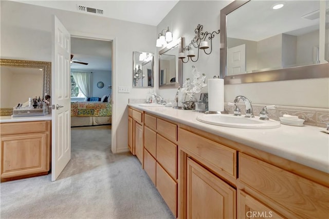 bathroom with ceiling fan and vanity