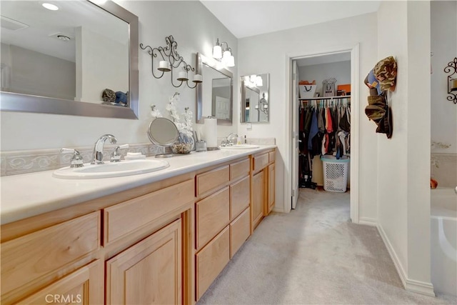 bathroom featuring vanity and a bath