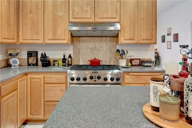 kitchen featuring light brown cabinetry and stainless steel gas stove