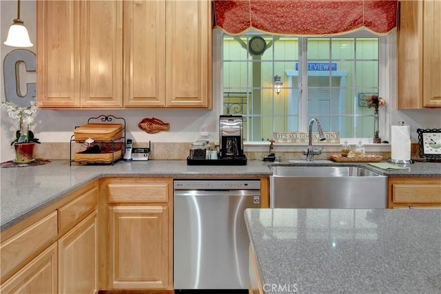 kitchen featuring dishwasher, pendant lighting, light brown cabinetry, and sink