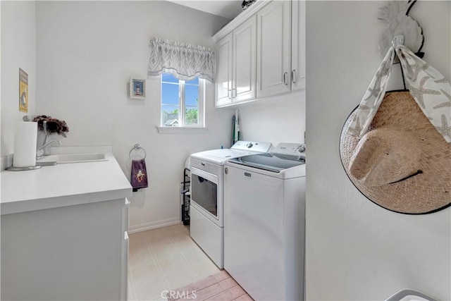 laundry room with cabinets, separate washer and dryer, and sink