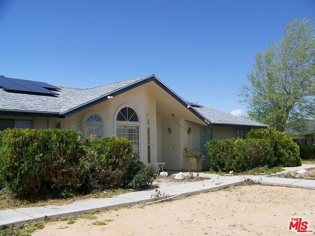 single story home featuring solar panels