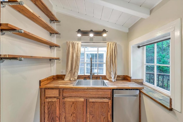 kitchen featuring lofted ceiling with beams, a healthy amount of sunlight, and sink