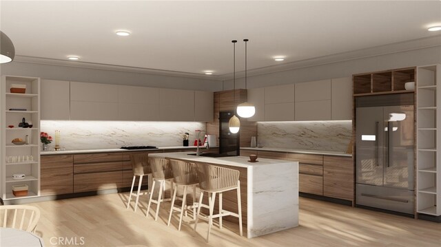 kitchen with pendant lighting, light wood-type flooring, a center island, a breakfast bar, and built in refrigerator