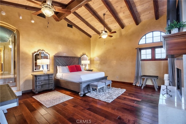 bedroom with high vaulted ceiling, dark hardwood / wood-style floors, and beam ceiling