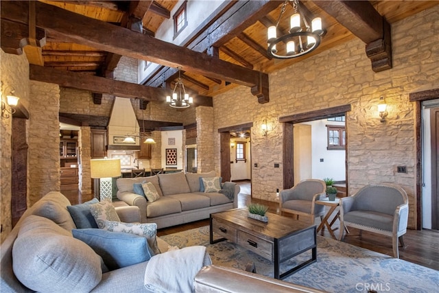 living room with wooden ceiling, dark wood-type flooring, a chandelier, high vaulted ceiling, and beam ceiling