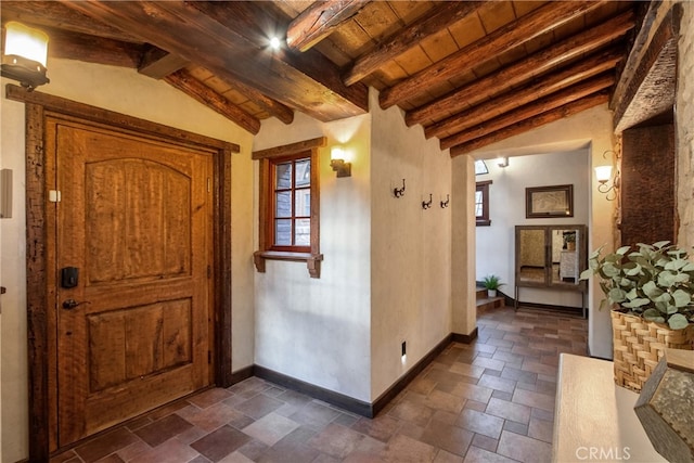 interior space with wooden ceiling and vaulted ceiling with beams