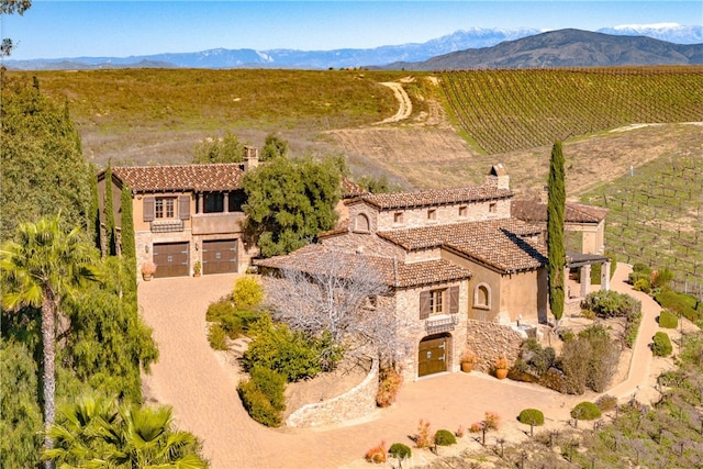 birds eye view of property with a mountain view