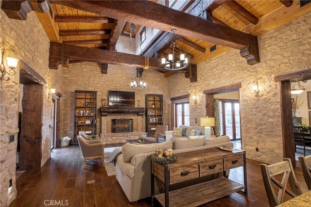 living room featuring wood ceiling, beam ceiling, a chandelier, and dark hardwood / wood-style floors