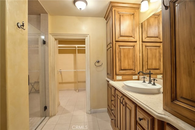 bathroom with walk in shower, tile flooring, and oversized vanity