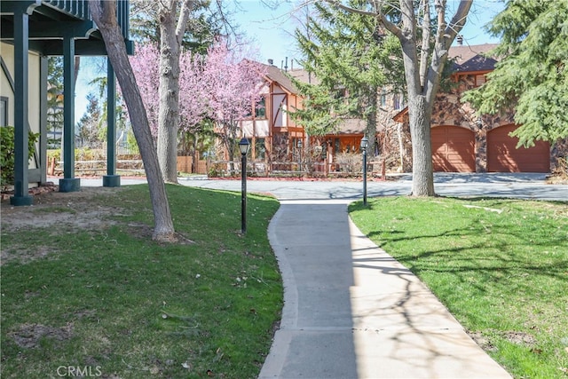 surrounding community with a yard and a garage