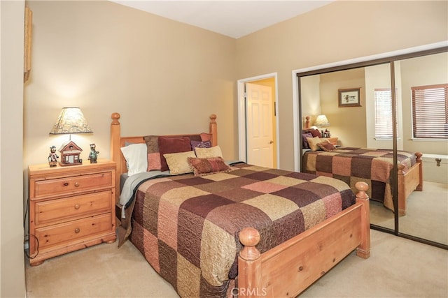 bedroom featuring light carpet and a closet