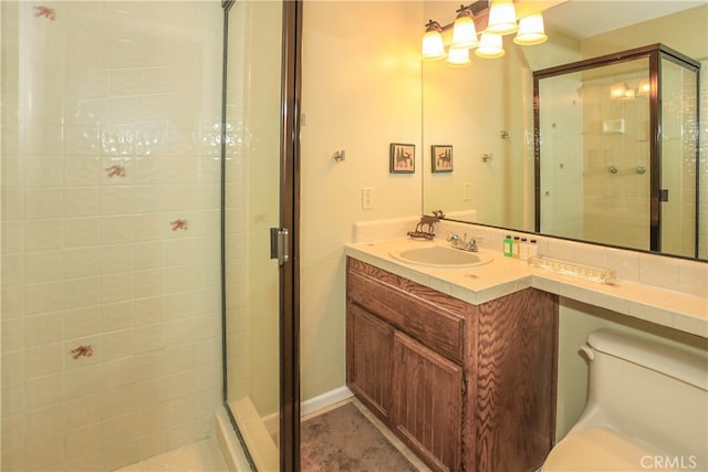 bathroom featuring vanity, toilet, and walk in shower