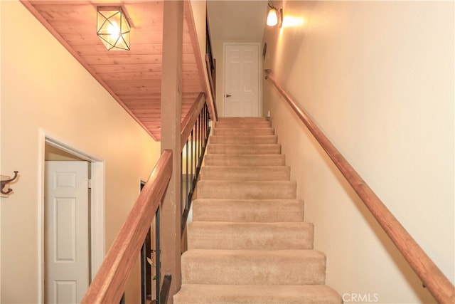 staircase with wood ceiling