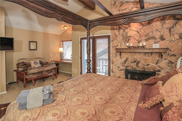 bedroom with a stone fireplace, light colored carpet, and vaulted ceiling with beams