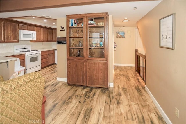 39802 Lakeview Dr Unit 12, Big Bear Lake, CA 92315 - kitchen featuring brown cabinets, light wood finished floors, recessed lighting, light countertops, and white appliances
