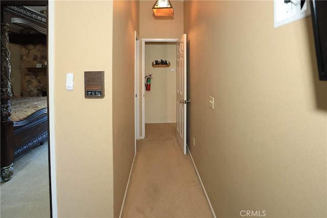 39802 Lakeview Dr Unit 12, Big Bear Lake, CA 92315 - hallway with baseboards and light colored carpet