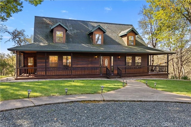 farmhouse-style home with a front yard and covered porch