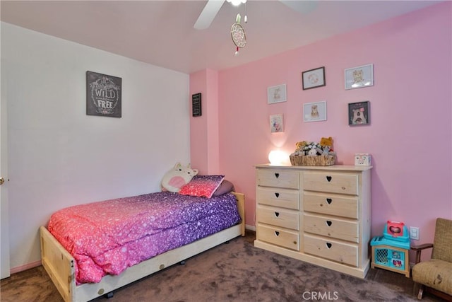 bedroom with ceiling fan and dark colored carpet