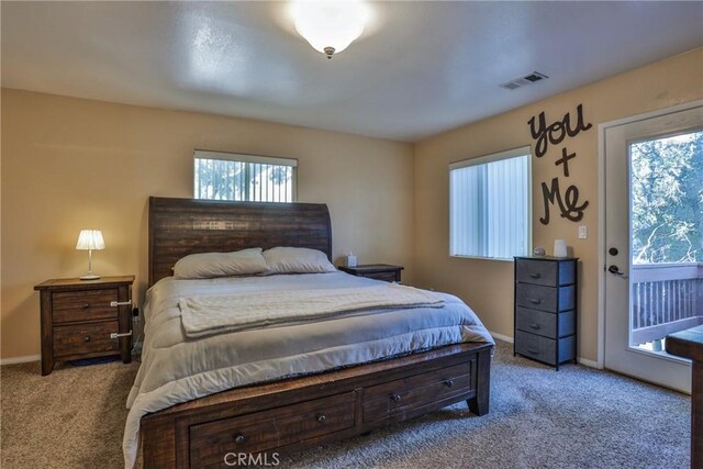 carpeted bedroom featuring access to outside