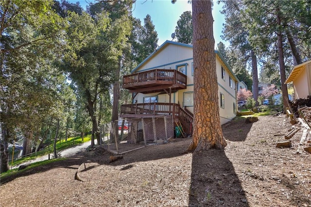 back of house featuring a wooden deck