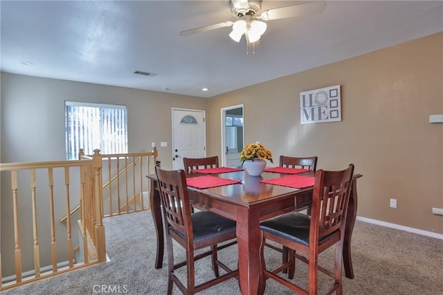 carpeted dining area featuring ceiling fan