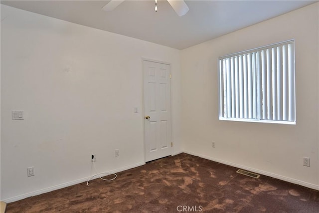 carpeted spare room with ceiling fan