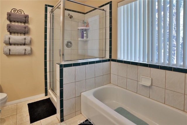 bathroom with toilet, tile patterned floors, and separate shower and tub