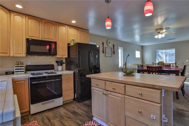 kitchen with ceiling fan, dark wood-type flooring, black appliances, pendant lighting, and butcher block countertops