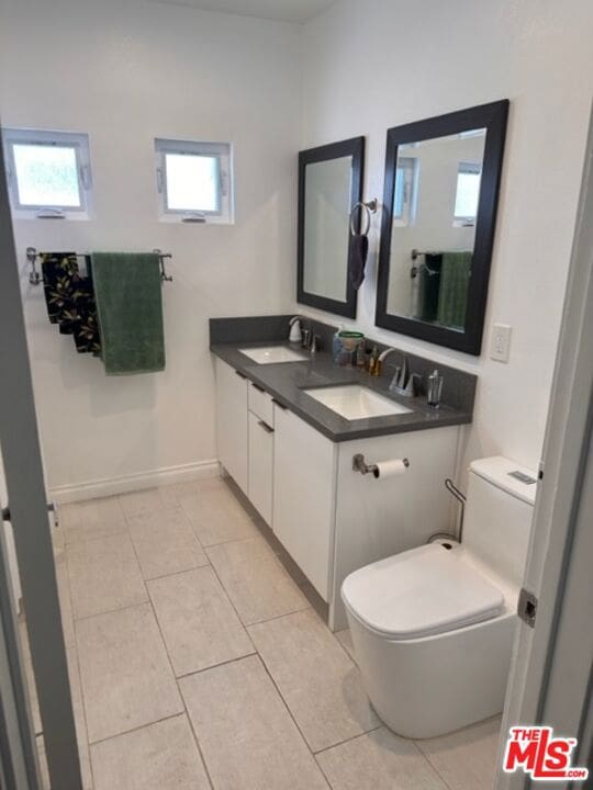 bathroom featuring vanity, toilet, and tile patterned floors