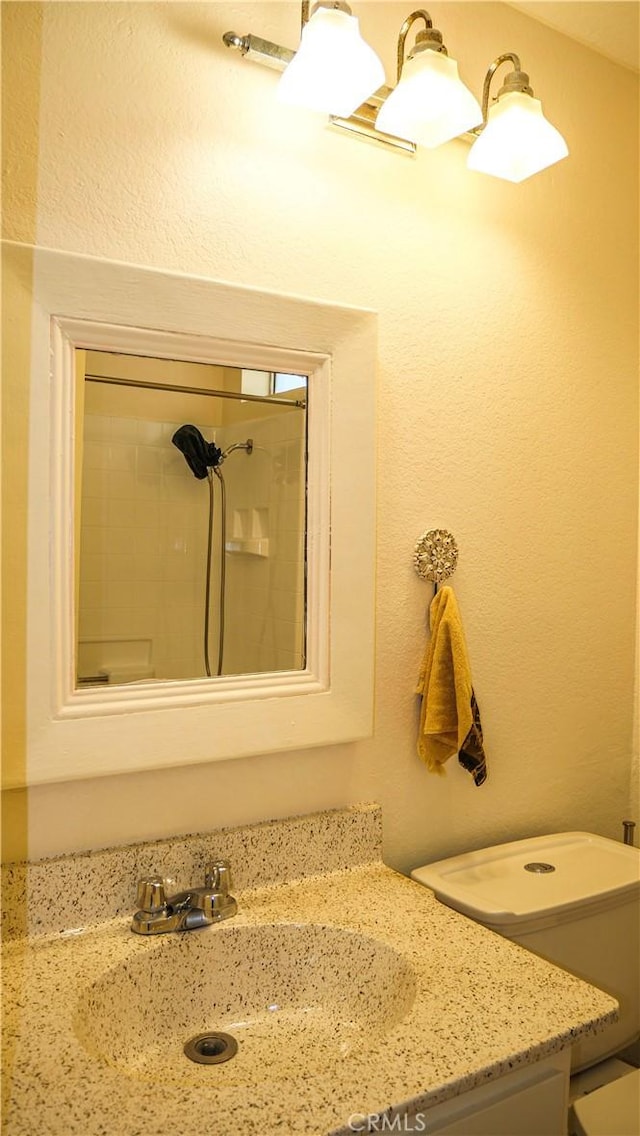 bathroom featuring vanity and tiled shower