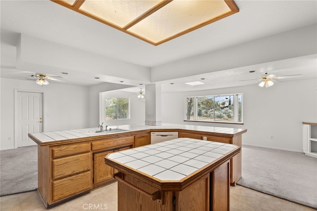 kitchen featuring light colored carpet, tile counters, sink, and white dishwasher