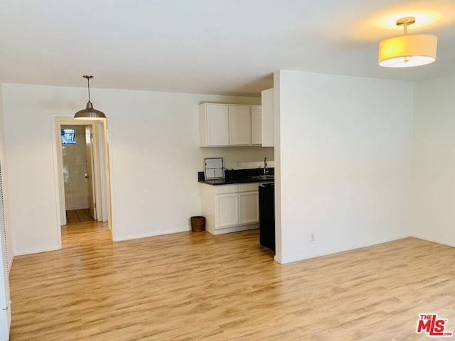 kitchen featuring light hardwood / wood-style floors, pendant lighting, and white cabinets