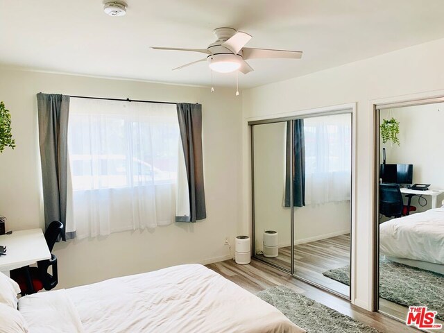 bedroom featuring light hardwood / wood-style floors and ceiling fan