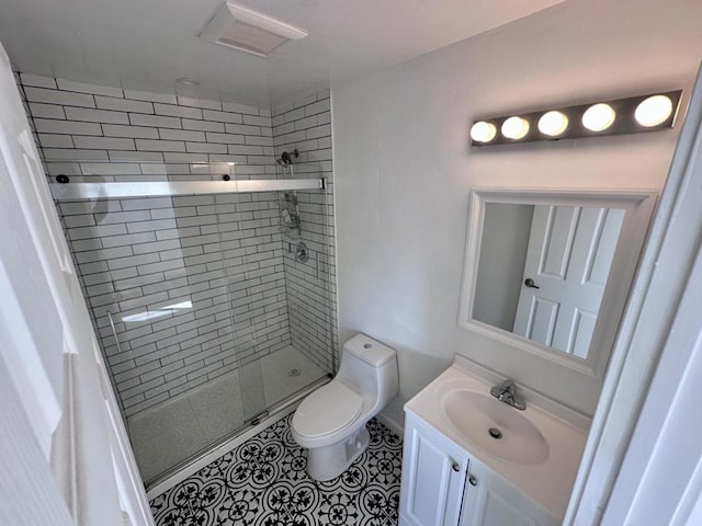 bathroom featuring walk in shower, vanity, toilet, and tile patterned flooring