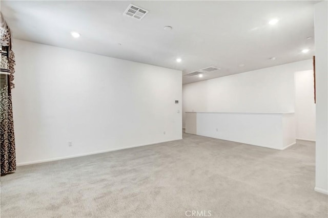 unfurnished room featuring light carpet