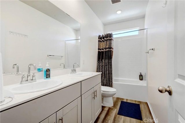 full bathroom with toilet, shower / tub combo, vanity, and hardwood / wood-style flooring