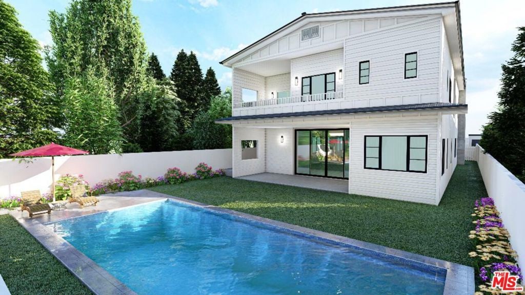 back of house with a fenced in pool and a lawn