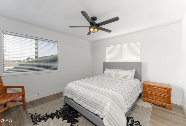 bedroom with light wood-type flooring and ceiling fan