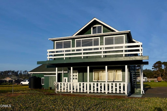 rear view of property featuring a lawn