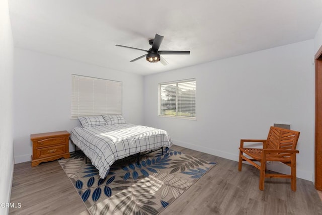 bedroom with light wood-type flooring and ceiling fan