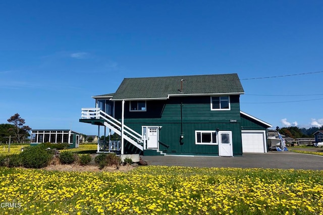 rear view of property with a garage