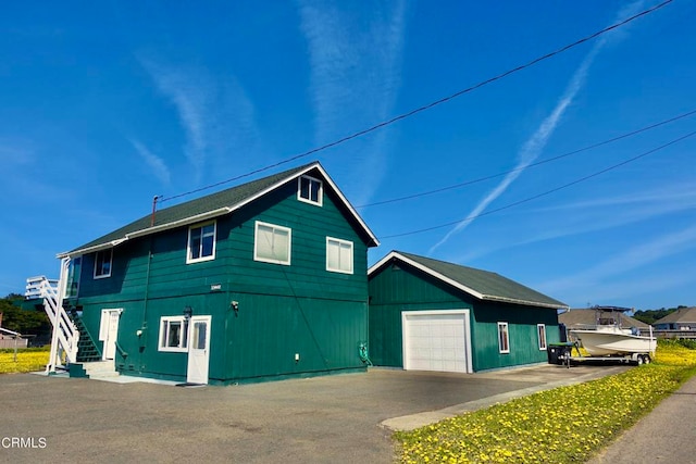 view of front of property with an outdoor structure and a garage